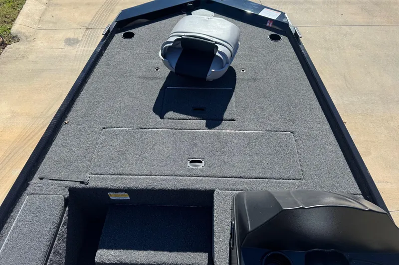 Slide: The Image of 2026 Crestliner 1600 Storm boat interior with carpeted deck and seating. - 4