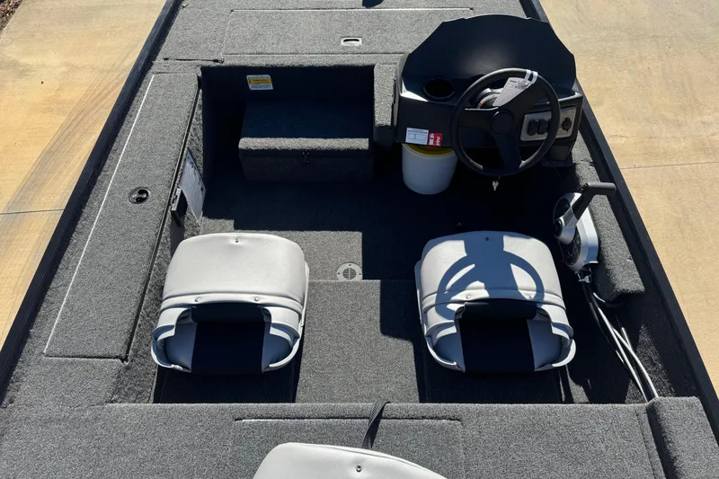 Slide: The Image of 2026 Crestliner 1600 Storm boat interior with steering wheel and seating. - 5