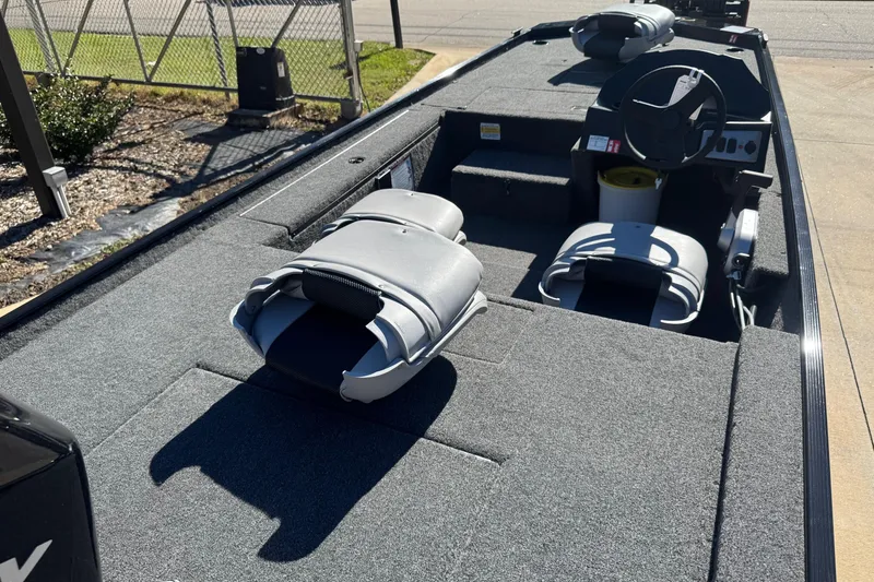 Slide: The Image of 2026 Crestliner 1600 Storm boat interior with gray seating and steering console. - 6