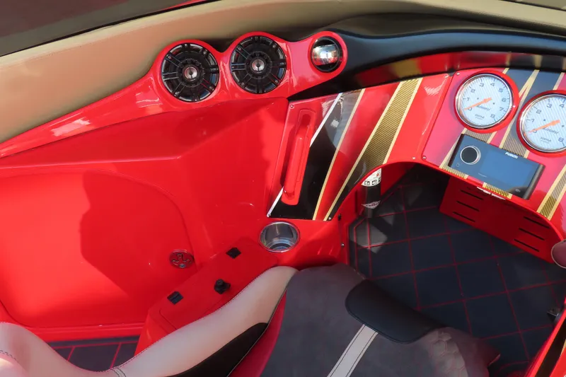 Slide: The Image of 2010 MTI 36 R/P boat interior with red dashboard, gauges, and luxurious seating. - 13