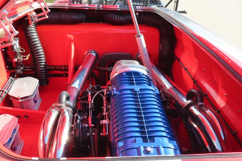 Slide: The Image of High-performance engine in a 2010 MTI 36 R/P boat, featuring vibrant red and blue components. - 16