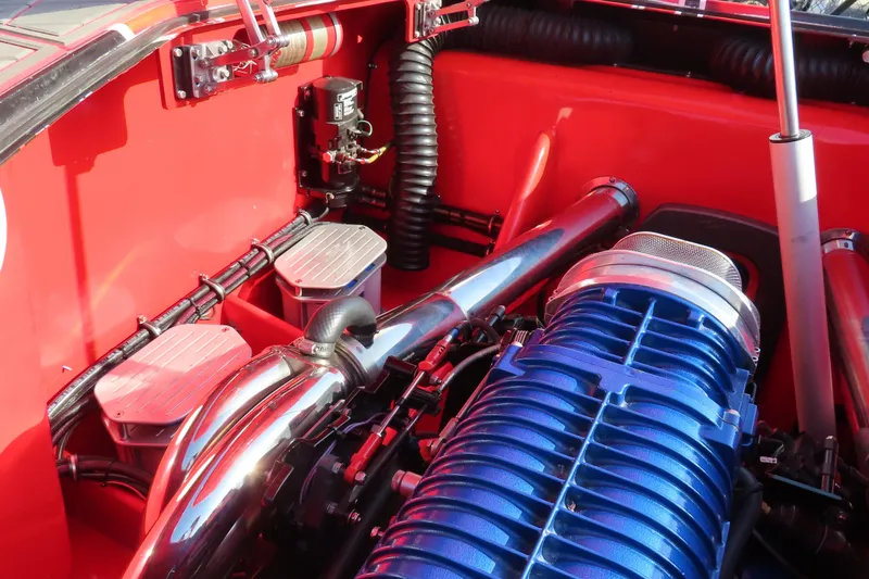 Slide: The Image of Engine compartment of 2010 MTI 36 R/P with blue and chrome components. - 18