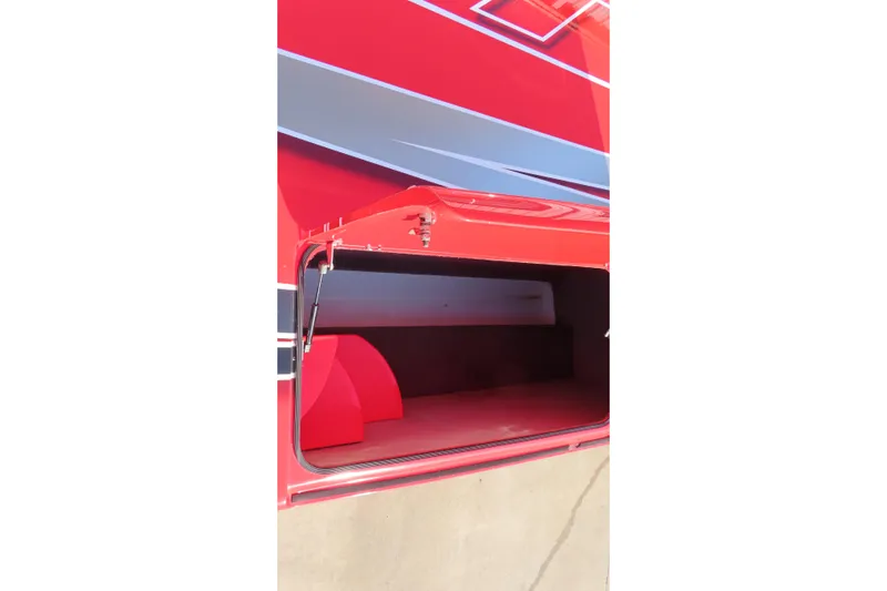 Slide: The Image of Open storage compartment on a red 2010 MTI 36 R/P boat. - 21