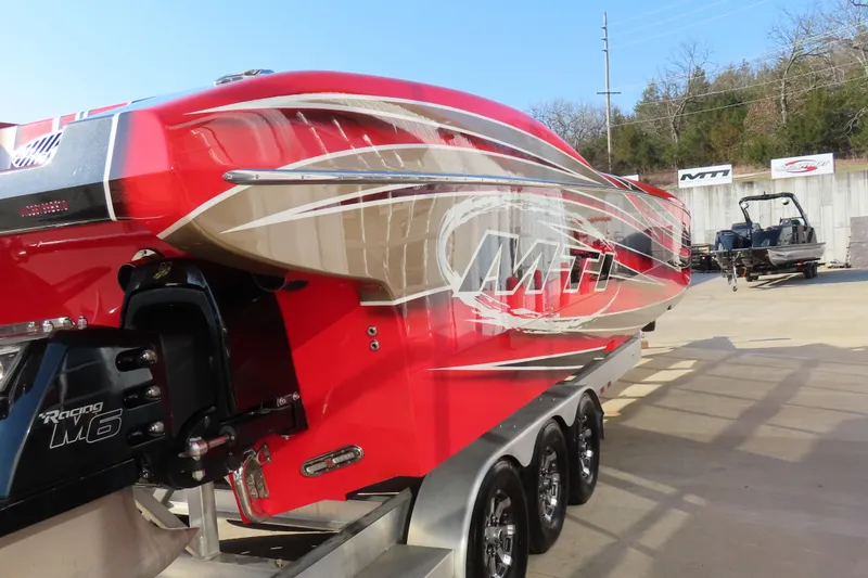 Slide: The Image of Red 2010 MTI 36 R/P powerboat on trailer, featuring sleek design and bold graphics. - 5