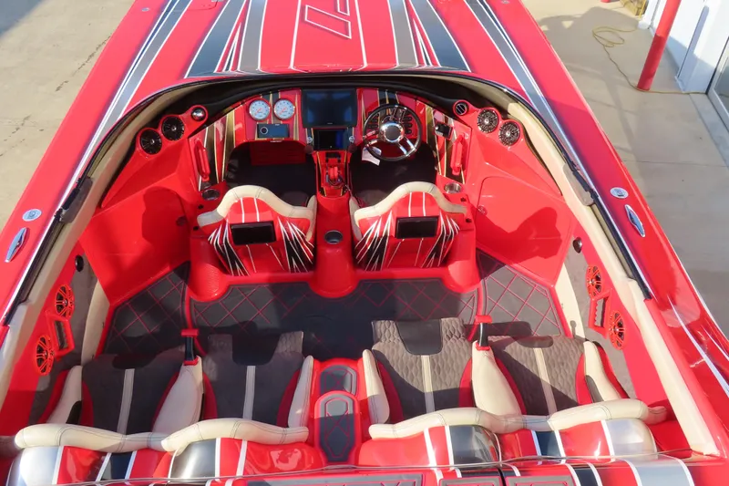 Slide: The Image of Red and black interior of 2010 MTI 36 R/P boat, featuring sporty seats and dashboard. - 9
