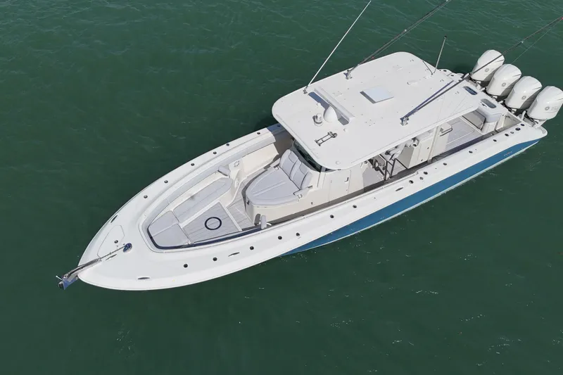 Slide: The Image of 2017 HCB 42 Siesta boat on water, aerial view, sleek design, multiple outboard engines. - 11