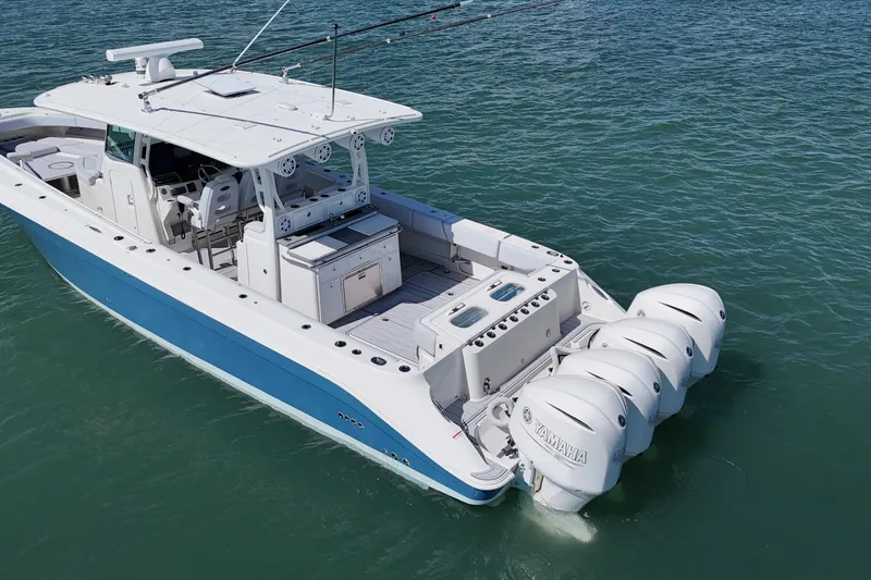 Slide: The Image of 2017 HCB 42 Siesta boat with four Yamaha outboard engines on the water. - 12