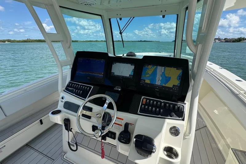 Slide: The Image of Helm of 2017 HCB 42 Siesta boat with navigation screens and steering wheel. - 16