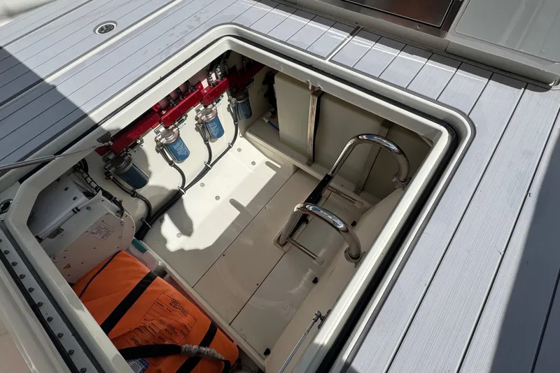 Slide: The Image of 2017 HCB 42 Siesta boat storage compartment with equipment and safety gear. - 22