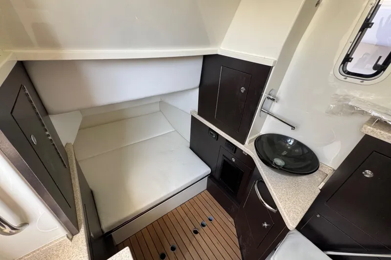 Slide: The Image of 2017 HCB 42 Siesta cabin interior with bed, sink, and wooden flooring. - 26