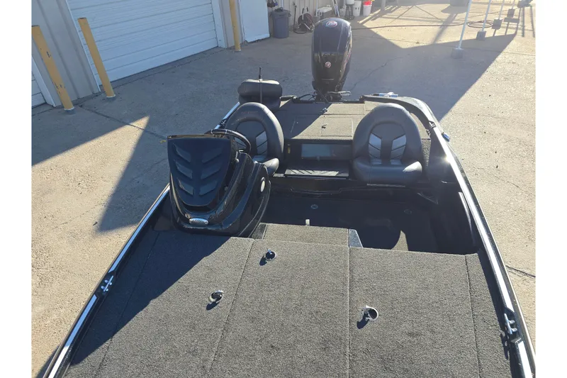 Slide: The Image of 2018 Nitro Z17 boat with dual seats and motor, parked outdoors. - 17