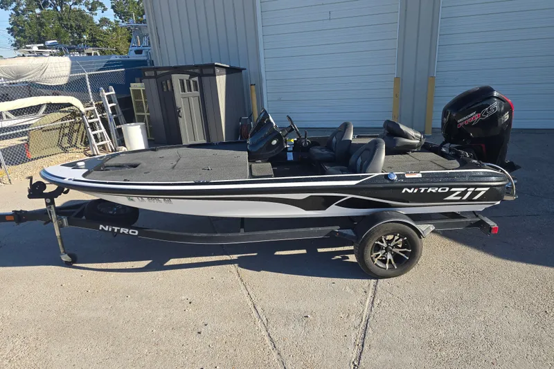 Slide: The Image of 2018 Nitro Z17 fishing boat on trailer, parked outdoors. - 2