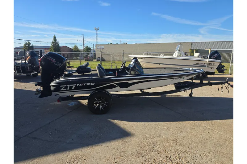 Slide: The Image of 2018 Nitro Z17 boat with trailer in outdoor lot, clear sky background. - 6