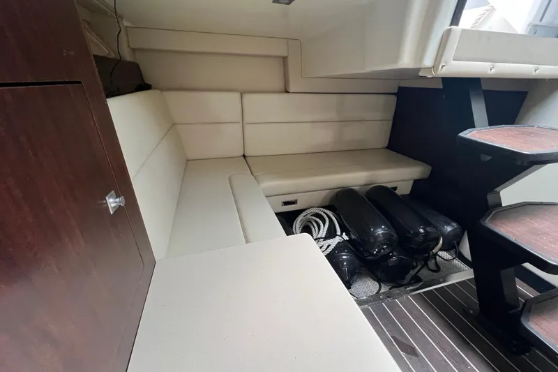 Slide: The Image of Interior of 2014 Monterey 320 Sport Yacht with seating and storage area. - 13