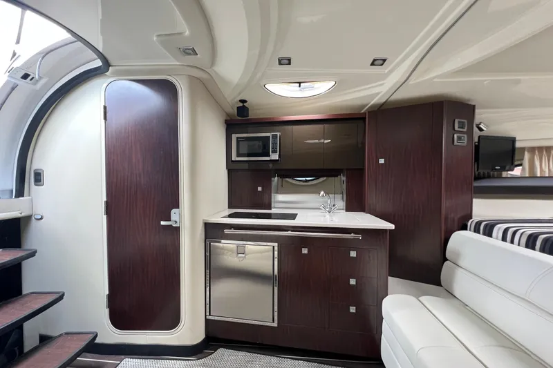 Slide: The Image of Luxurious interior of 2014 Monterey 320 Sport Yacht with modern kitchenette and seating area. - 14