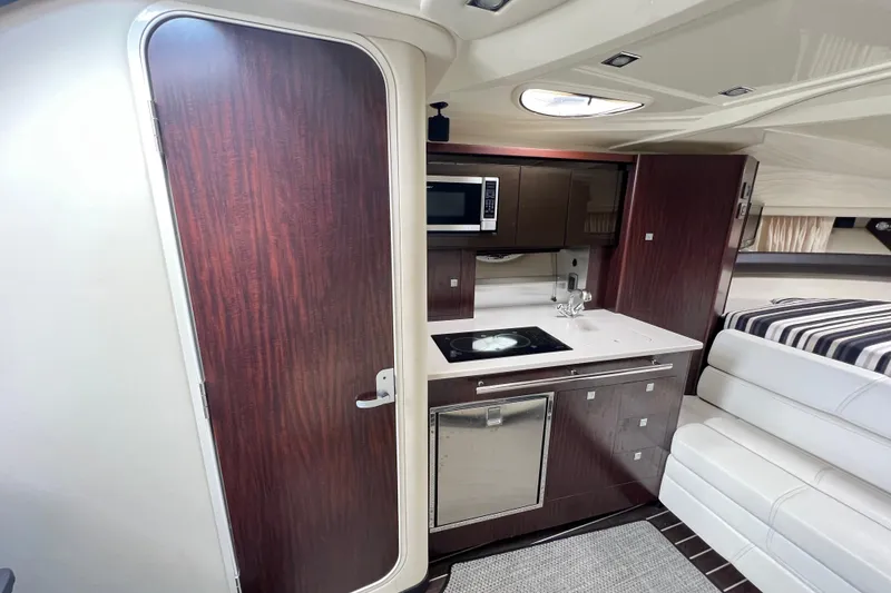 Slide: The Image of Interior of 2014 Monterey 320 Sport Yacht with kitchenette and seating area. - 15