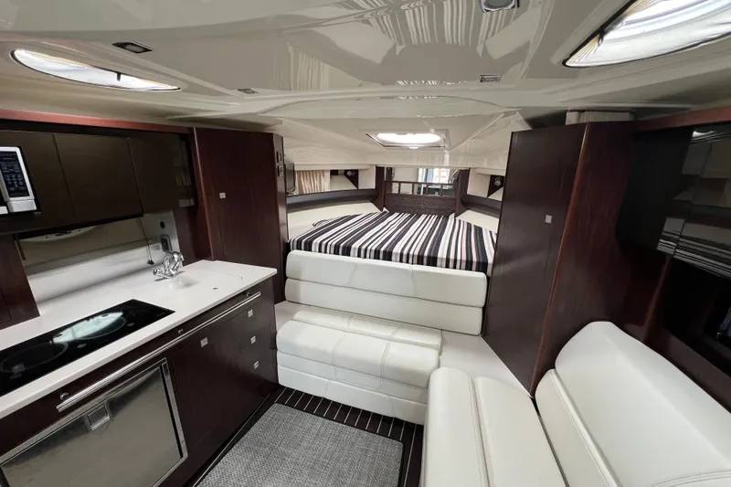 Slide: The Image of Luxurious interior of 2014 Monterey 320 Sport Yacht with modern kitchen and cozy sleeping area. - 16