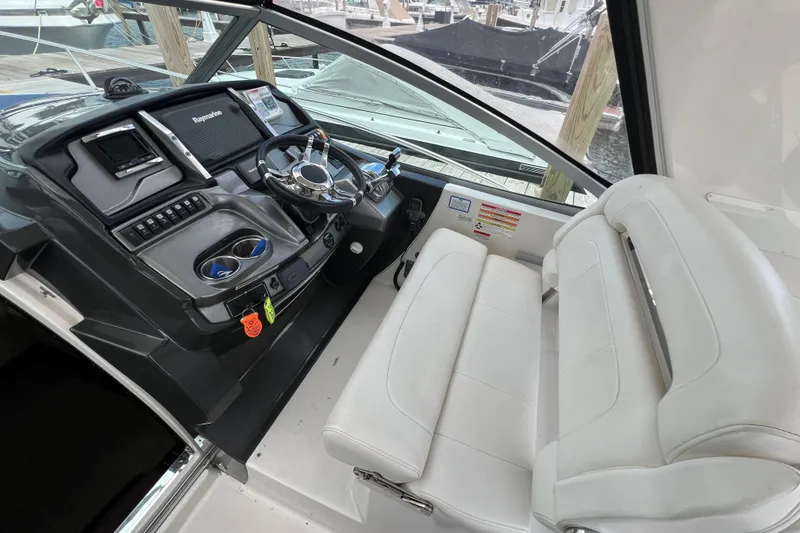 Slide: The Image of Cockpit of 2014 Monterey 320 Sport Yacht with steering wheel and controls. - 8