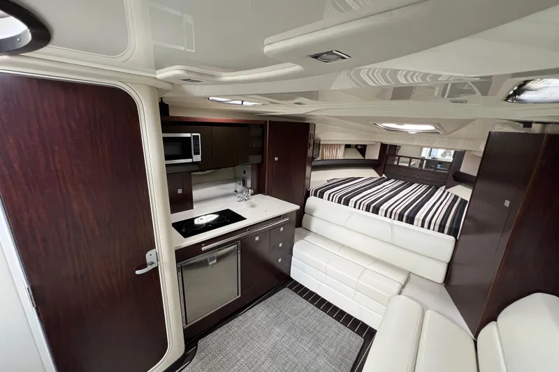 Slide: The Image of Luxurious interior of 2014 Monterey 320 Sport Yacht with kitchenette and cozy sleeping area. - 9