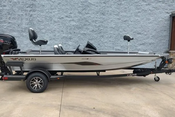 The Image of 2026 Vexus 189D boat on trailer, sleek design, gray exterior, parked outdoors. - 1