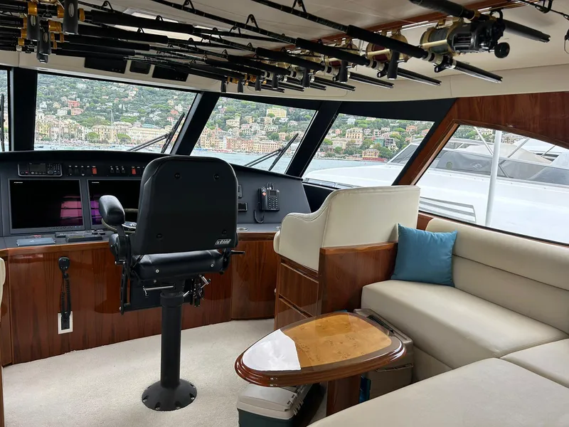 Slide: The Image of Interior of 2018 Viking 62 Enclosed Bridge yacht with helm and seating area. - 14