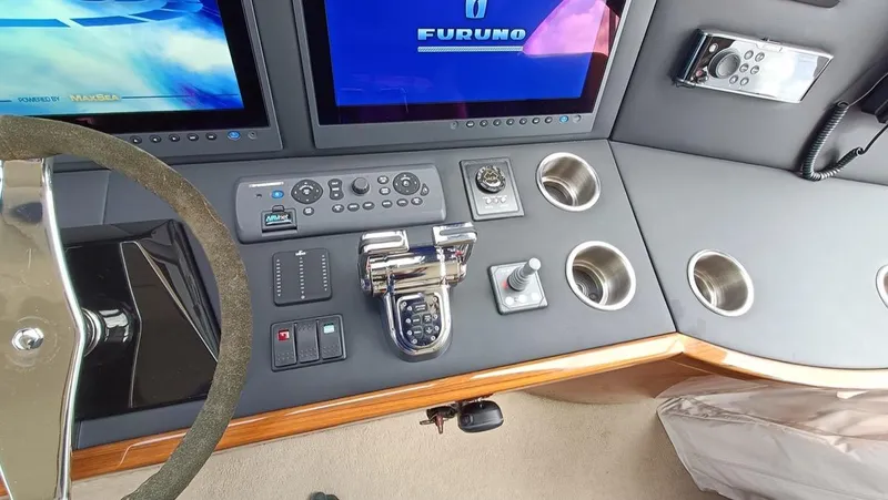 Slide: The Image of Control panel of 2018 Viking 62 Enclosed Bridge yacht with navigation screens and controls. - 26