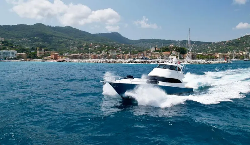 Slide: The Image of 2018 Viking 62 Enclosed Bridge yacht cruising on blue ocean near scenic coastline. - 6