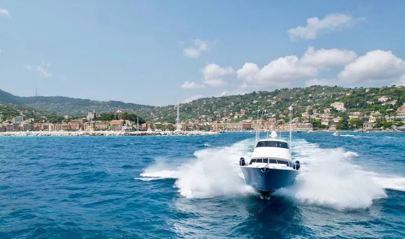 Slide: The Image of 2018 Viking 62 Enclosed Bridge yacht cruising on blue ocean near scenic coastline. - 7