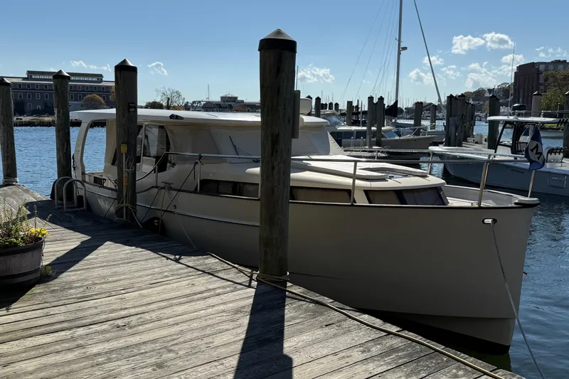 Slide: The Image of 2013 Greenline 33 yacht docked at a marina on a sunny day. - 2