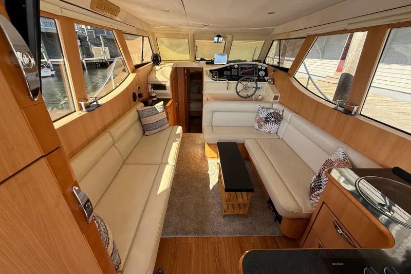 Slide: The Image of Interior of 2013 Greenline 33 yacht with beige seating and wooden accents. - 21