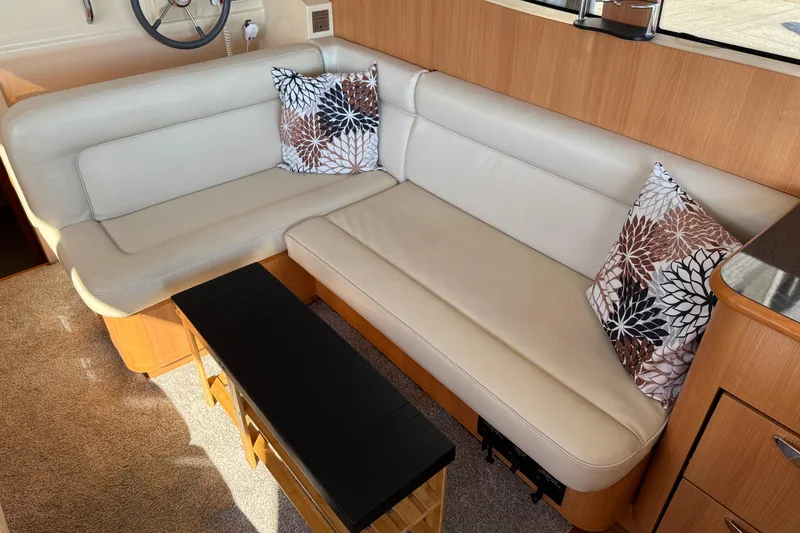 Slide: The Image of Interior of 2013 Greenline 33 yacht with beige leather seating and decorative pillows. - 22
