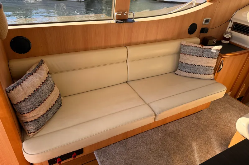 Slide: The Image of Luxurious interior of 2013 Greenline 33 yacht with beige sofa and decorative pillows. - 23