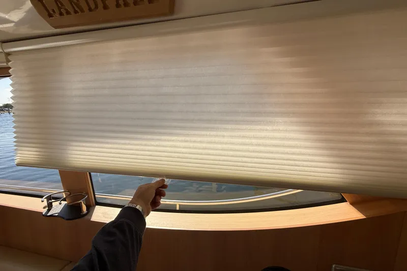 Slide: The Image of Person adjusting window blind on 2013 Greenline 33 yacht interior. - 24