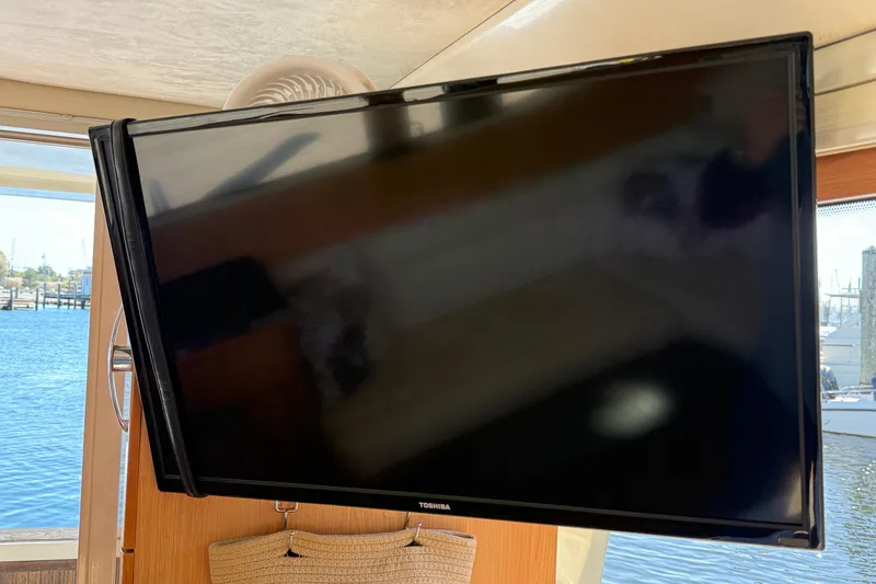 Slide: The Image of Toshiba TV inside 2013 Greenline 33 yacht, with marina view through window. - 25