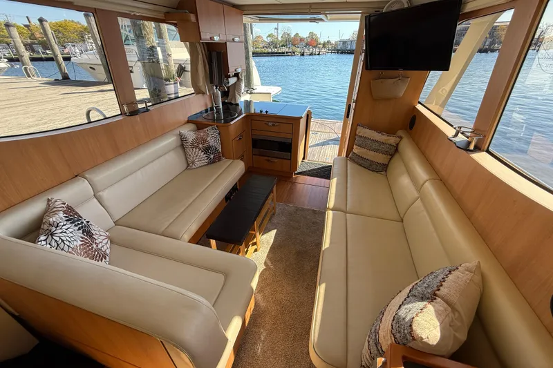 Slide: The Image of Luxurious interior of 2013 Greenline 33 yacht with beige seating and waterfront view. - 26