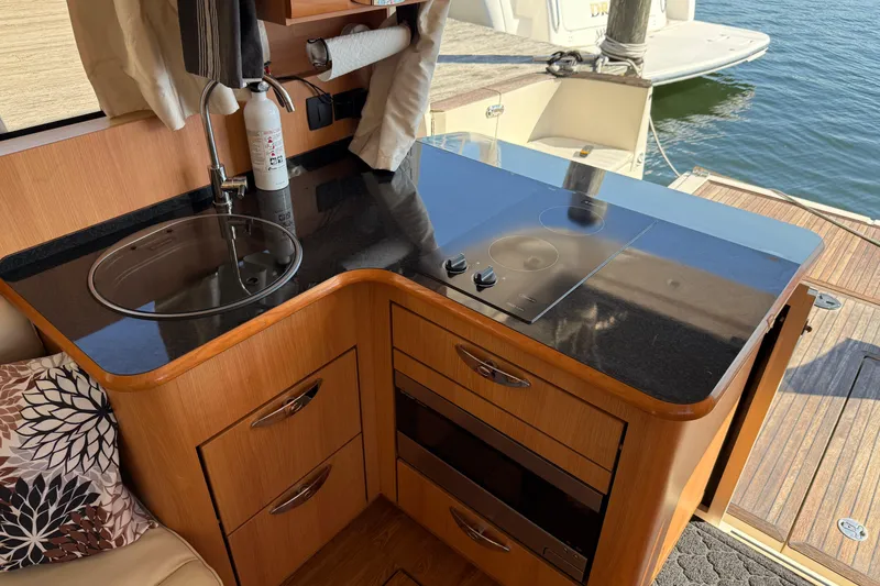 Slide: The Image of Compact kitchen area in a 2013 Greenline 33 yacht with stove and sink. - 28