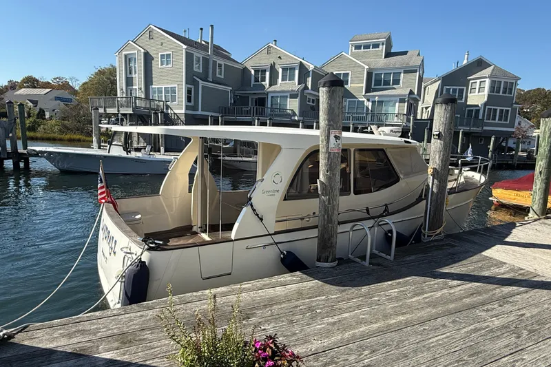 Slide: The Image of 2013 Greenline 33 boat docked near waterfront homes on a sunny day. - 3