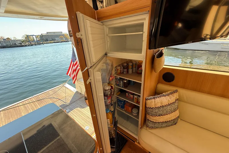 Slide: The Image of Interior of 2013 Greenline 33 yacht with open fridge and waterfront view. - 30