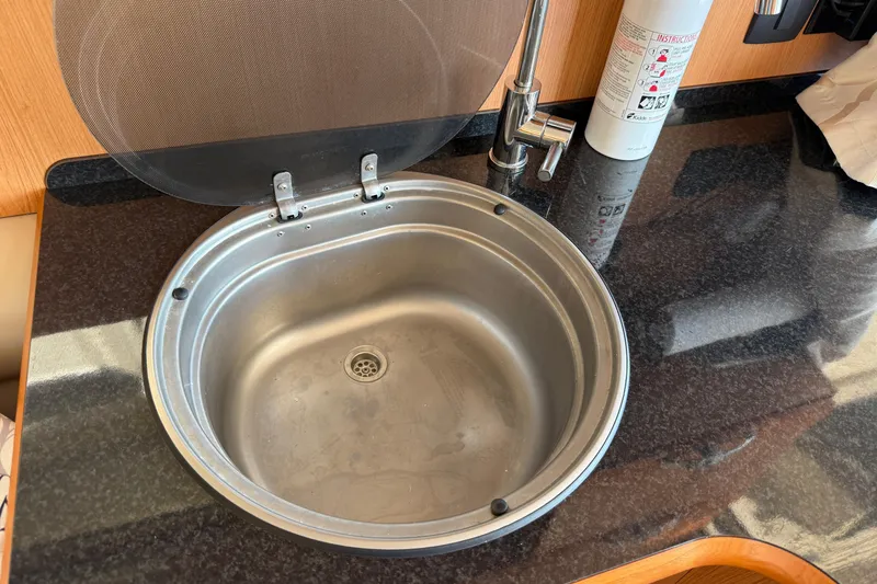 Slide: The Image of Stainless steel sink in 2013 Greenline 33 yacht kitchen with black countertop. - 31