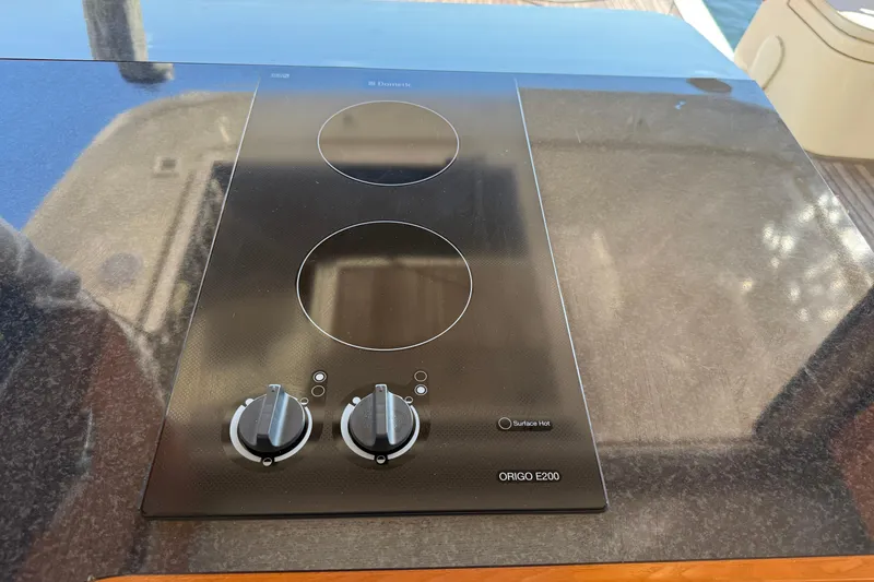 Slide: The Image of Ceramic cooktop on 2013 Greenline 33 yacht, featuring dual burners and control knobs. - 32