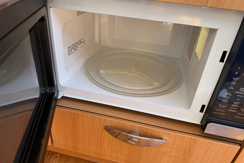 Slide: The Image of Open microwave oven with wooden cabinetry, Greenline 33, 2013 model. - 34