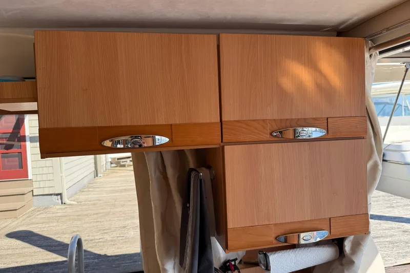Slide: The Image of Wooden cabinets inside a 2013 Greenline 33 boat, featuring sleek chrome handles. - 35