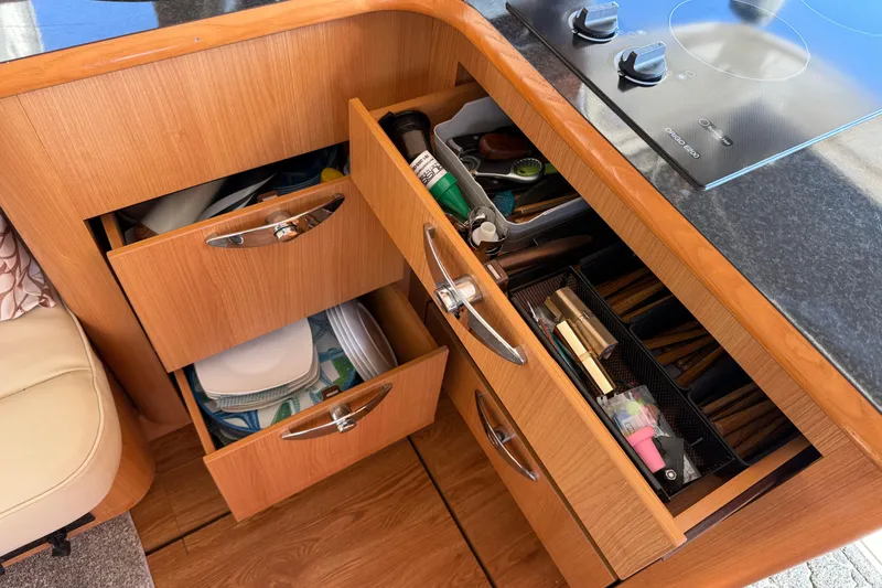 Slide: The Image of Kitchen drawers in a 2013 Greenline 33 yacht, containing utensils and cookware. - 37