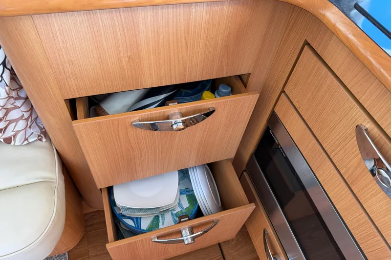 Slide: The Image of Wooden kitchen drawers in a 2013 Greenline 33 boat, storing plates and supplies. - 38