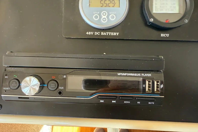 Slide: The Image of Audio system and control panel in a 2013 Greenline 33 boat, featuring USB ports and display. - 49