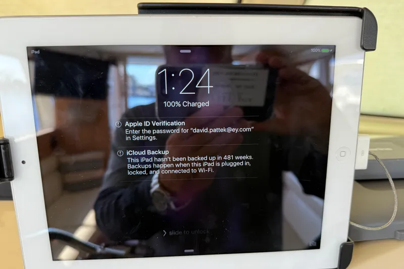 Slide: The Image of iPad displaying Apple ID verification and iCloud backup alert, mounted on a Greenline 33, 2013. - 50