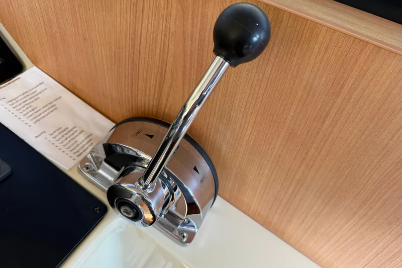 Slide: The Image of Throttle control lever on a 2013 Greenline 33 boat, mounted on a wooden panel. - 54