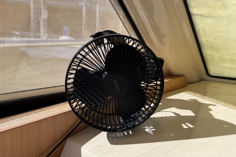 Slide: The Image of Black fan inside a 2013 Greenline 33 boat, placed near a window. - 58