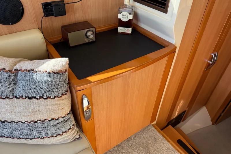 Slide: The Image of Interior of 2013 Greenline 33 yacht with wooden cabinetry and cozy seating area. - 61