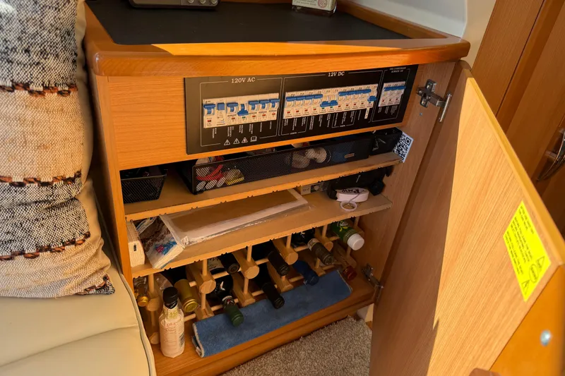 Slide: The Image of Electrical panel and storage cabinet inside a 2013 Greenline 33 boat. - 62